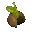 Cavern: Blurry green slime-like blob above a brown rock, with small glowing dots around.