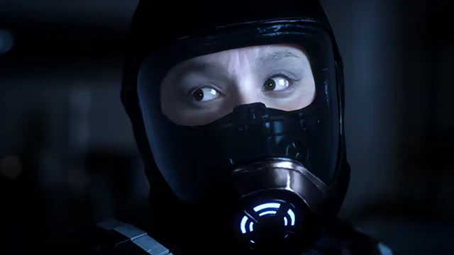 Project Vesperi: Person in a dark helmet with glowing blue lights, eyes focused intently.