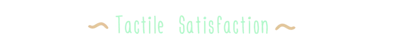 Tactile Satisfaction Text – Woodo Woodo: Mint-green text “Tactile Satisfaction” with tan wavy flourishes on black.