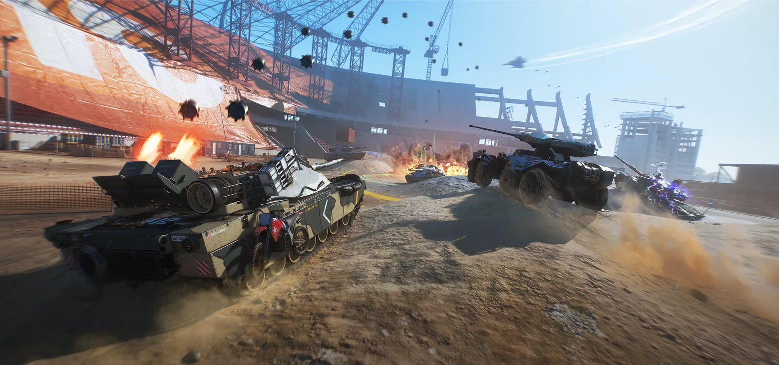 World of Tanks: Tanks race through a construction site as explosions and debris erupt ahead.